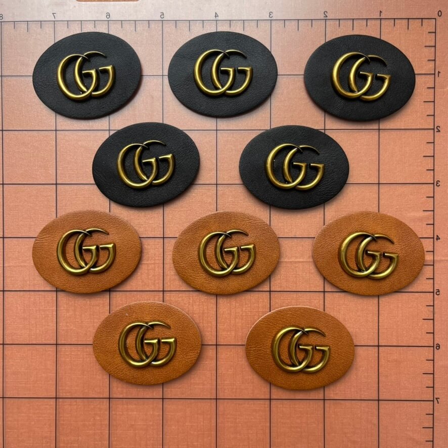 Sew-on Patches- oval shaped blk&brown leather label with metal gg*10 pcs
